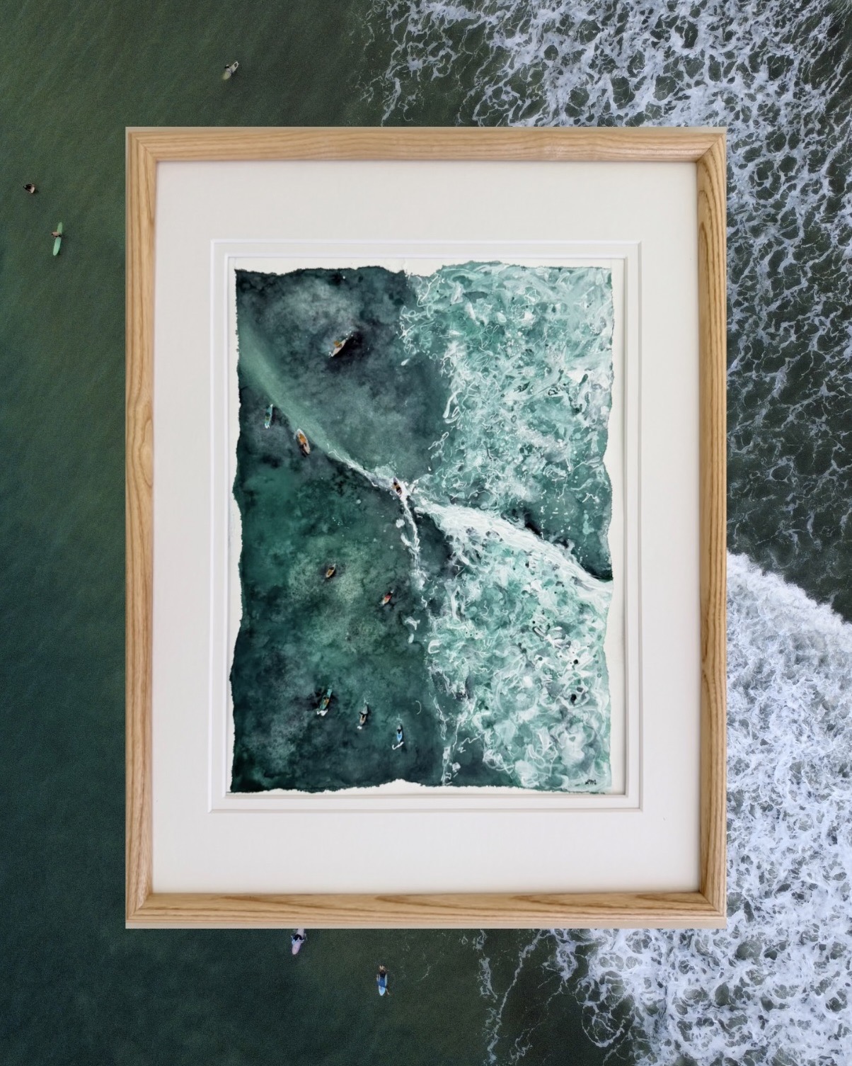 Framed aerial watercolor of surfers along a deep teal reef break